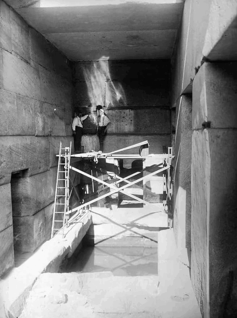 Henri Frankfort at the Osireion pointing to dovetail clamp linked to Seti I.